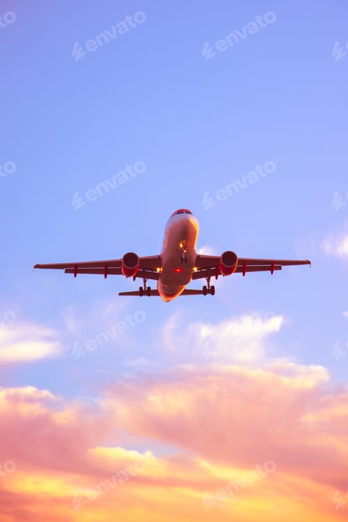 Preview: Airplane as seen from below landing during sunset flying