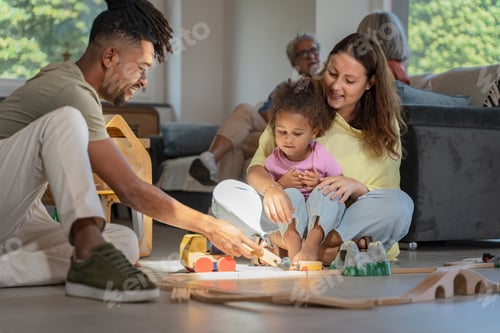 Vista previa: Interracial Family Engaging in Interactive Play with Toy Train