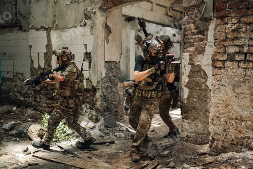 Preview: Air soft soldiers in formation attacking opponent in ruined building.