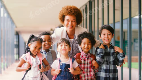 Preview: Portrait Of Smiling Multi-Cultural Elementary School Pupils With Female Teacher Outdoors At School