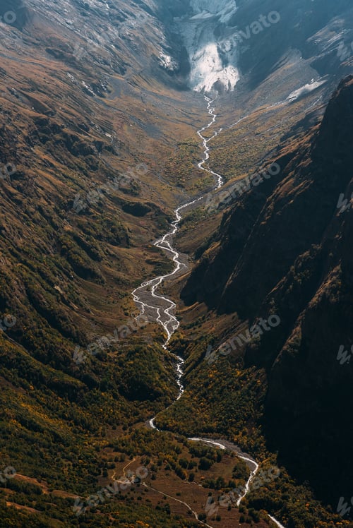Preview: Mountain autumn landscape of the gorge, vertical view. Mountain river in the Caucasus.