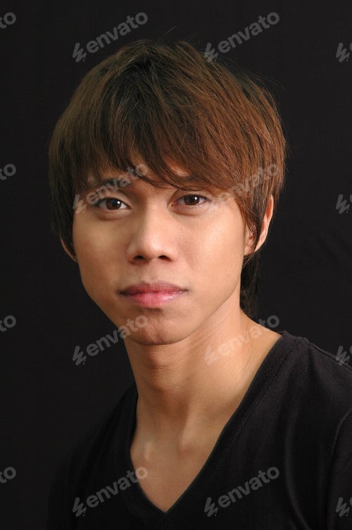 Preview: Selective closeup shot of a male with bangs and black shirt on a black background