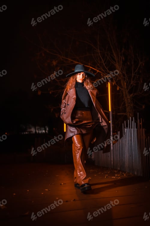 Preview: Girl in a hat in night on a parcel. Brunette Caucasian model looking at camera