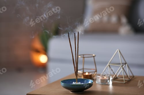 Preview: Incense sticks smoldering on table indoors, space for text