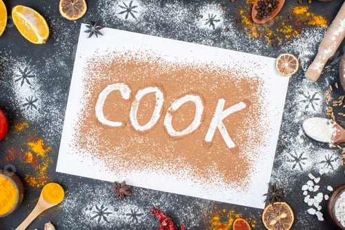 Preview: top view cook writing with eggs vegetables raw pasta and seasonings on a dark background dough