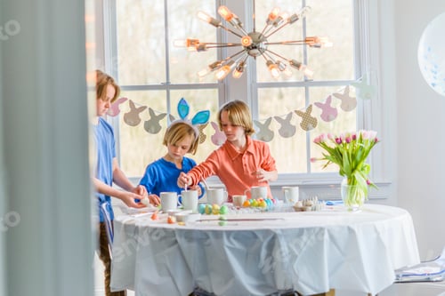 Preview: Boys at dining table decorating eggs for Easter