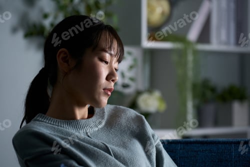 Preview: A woman thinking in a dark room