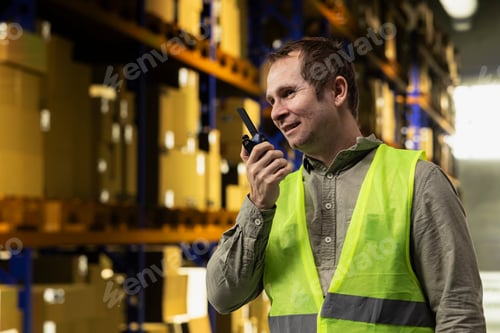 Preview: Professional using radio transmitter in industrial storage facility