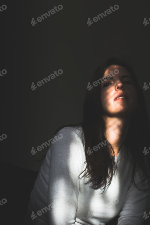 Preview: A portrait of a young woman half of her face is the shadow