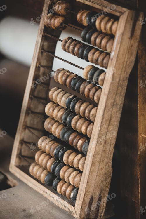 Preview: Old worn out wooden abacus on a table