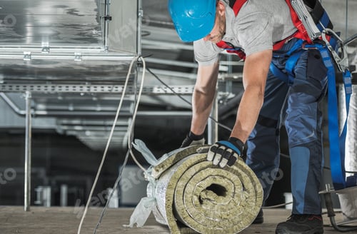 Preview: Worker with Piece of Mineral Wool Insulation