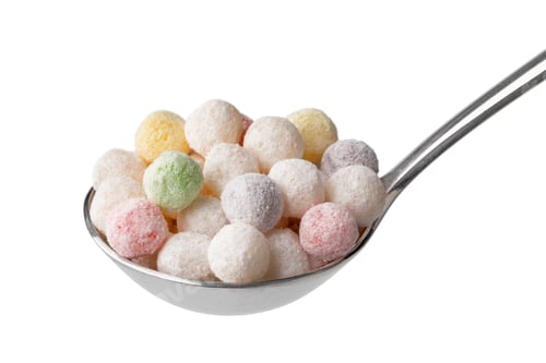 Preview: Metal spoon with uncooked colorful tapioca pearls close up on white background