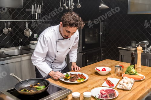 Preview: chef checking fried vegetables with meat