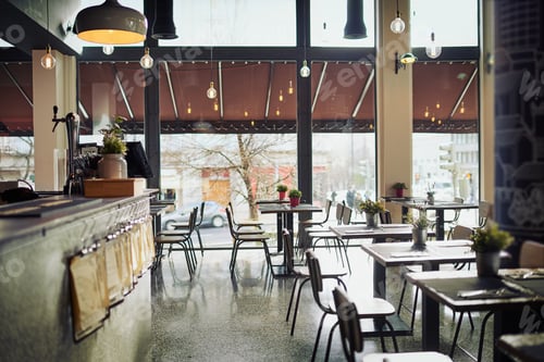 Preview: Shot of an empty restaurant filled with tables and chairs inside during the day