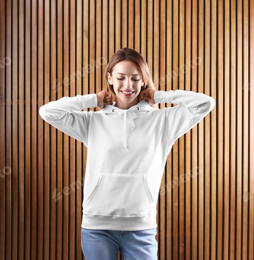 Preview: Portrait of woman in hoodie sweater on wooden background. Space for design