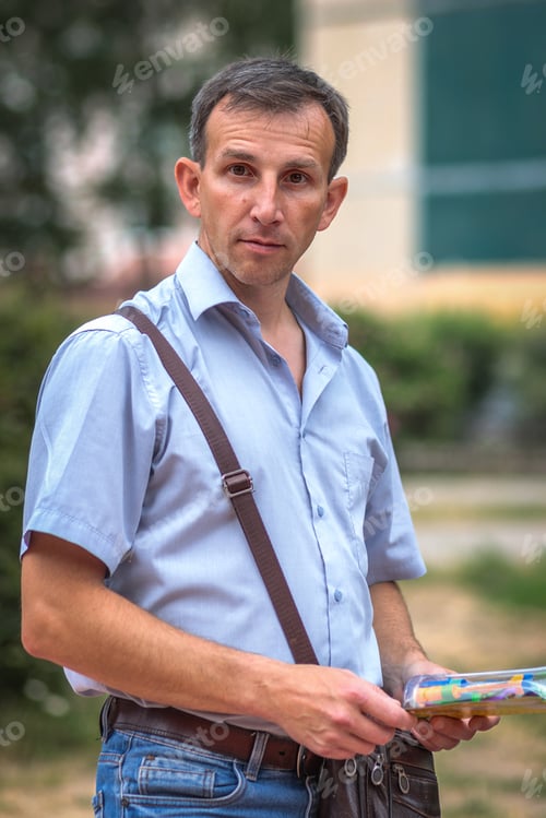 Preview: A man dressed in office clothes,a businessman,on the street waiting for a colleague for lunch break