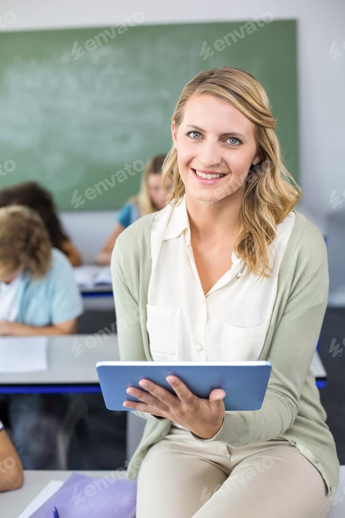 Preview: Portrait Of Female Teacher Using Digital Tablet In Her Class