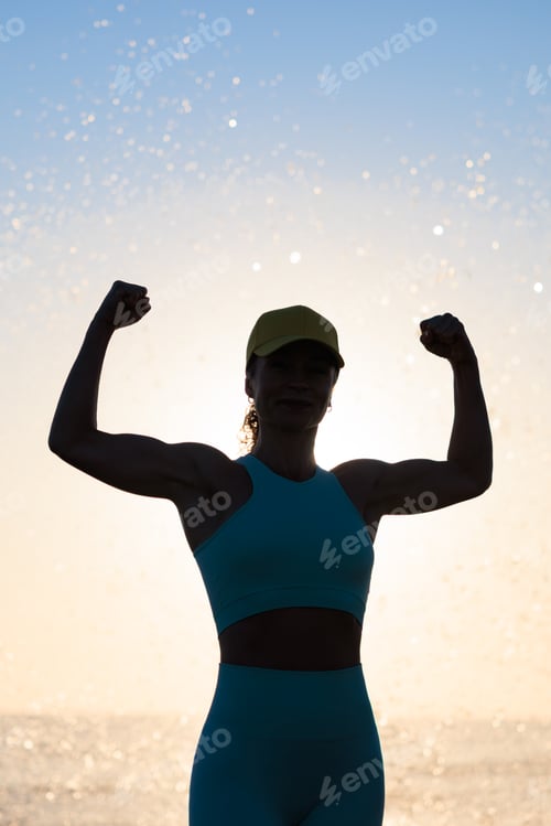 Preview: Fit young woman posing at the beach against sunrise during the summer vacation