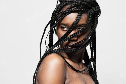 Preview: Portrait of a young woman with braided hair, showcasing beauty and confidence against a minimalistic