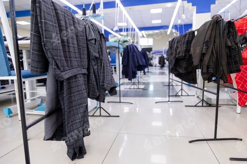 Preview: New clothes hanging on a stand in sewing factory