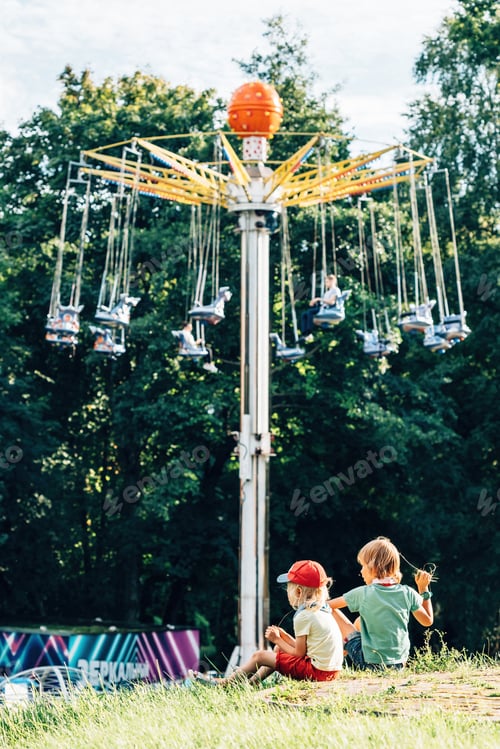 Preview: boys play on the hill opposite the carousel