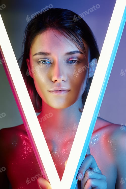 Preview: Sexy woman in neon light in lingerie. Neon lights and glare of light on the woman face