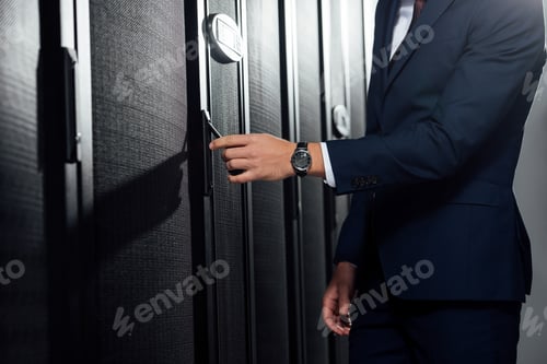 Preview: cropped view of businessman in suit standing in data center