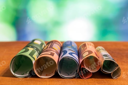 Preview: Euro Currency Rolled on Wooden Tabletop