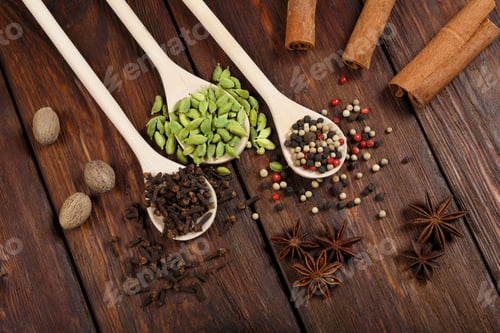 Preview: Variety Of Spices In Wooden Spoons Close-Up At The White Background