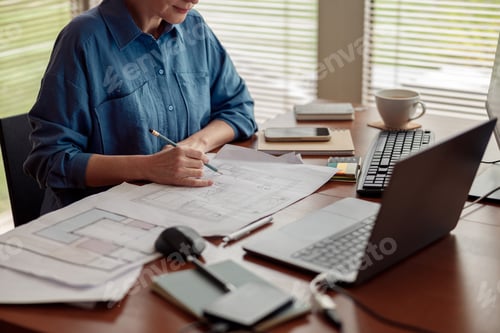 Preview: Woman engineer construction is developing construction project documentation sitting at home office