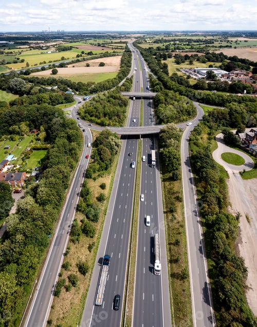 Preview: Aerial view above the M62 motorway with roundabout road junction