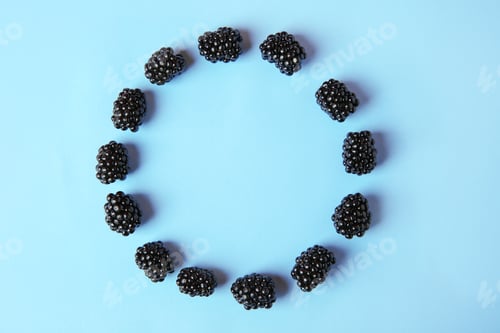Preview: Flat lay composition with ripe blackberries on blue background. Space for text