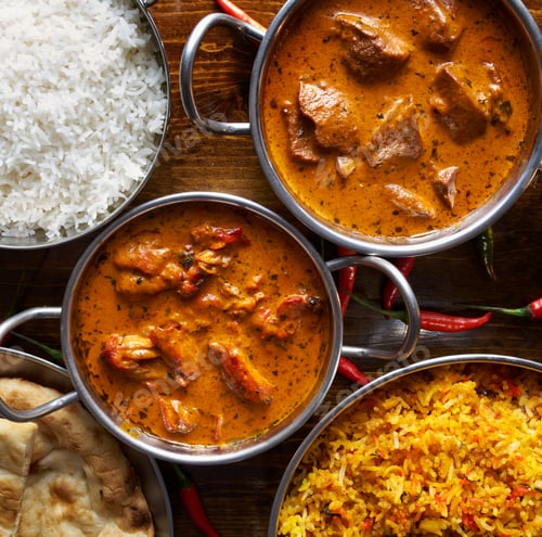 Preview: assortment of indian curry and rice dishes shot from overhead composition
