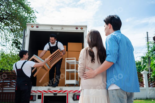 Preview: Asian Couple check while unloading boxes and furniture from a pickup truck