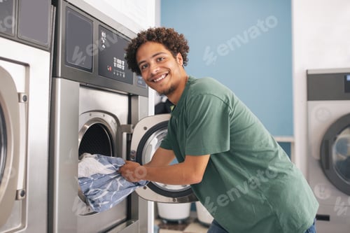 Preview: Latin Young Guy Loading Washing Machine Posing At Laundrette Room