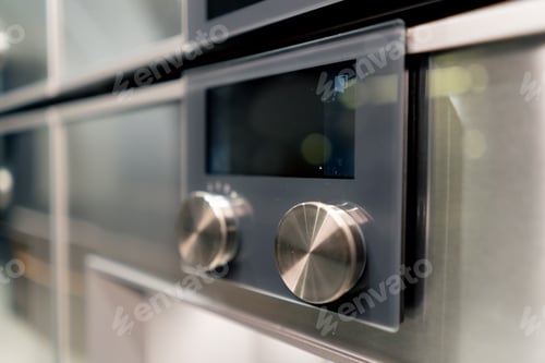 Preview: close-up of a professional kitchen with a metal part of the oven with temperature and time switches