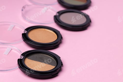 Preview: Set of eyeshadows make up products on pink