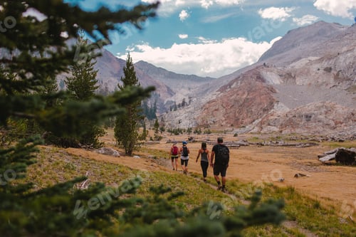 Preview: Three hikers exploring a mountainous trail.