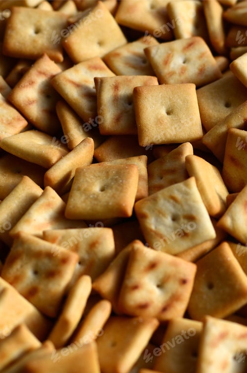Preview: Background texture of small edible squares baked from dough and sprinkled with salt