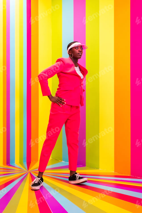 Preview: Beautiful young woman dancing and having fun inside a rainbow box room