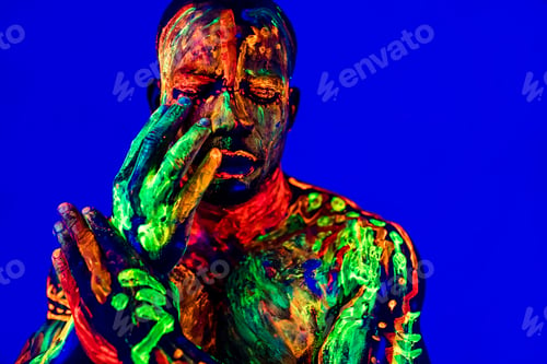 Preview: afro american man with UV body art posing in studio