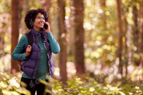 Preview: Woman On Hike Through Forest Talking On Mobile Phone
