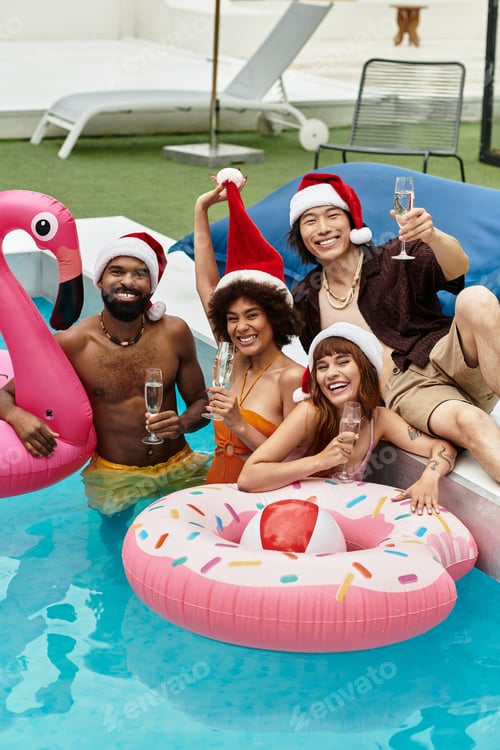 Preview: Young stylish friends enjoying a festive Christmas pool party in vibrant swimsuits