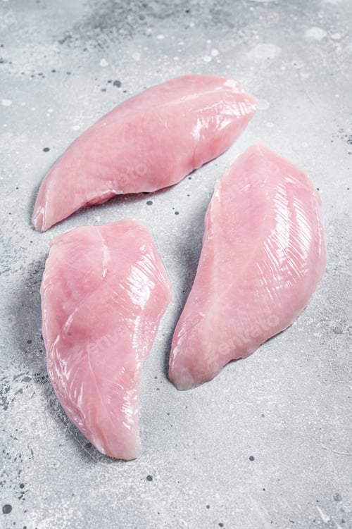 Preview: Raw Turkey Breasts fillet steaks. Gray background. Top view