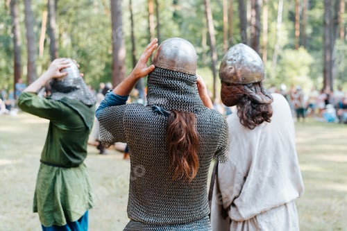 Preview: Back view of vikings in helmets preparing for battle in the forest
