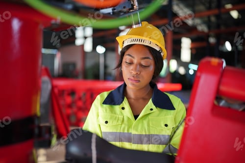 Preview: Robotics engineer working on maintenance of robotic arm in factory warehouse. Business technology.