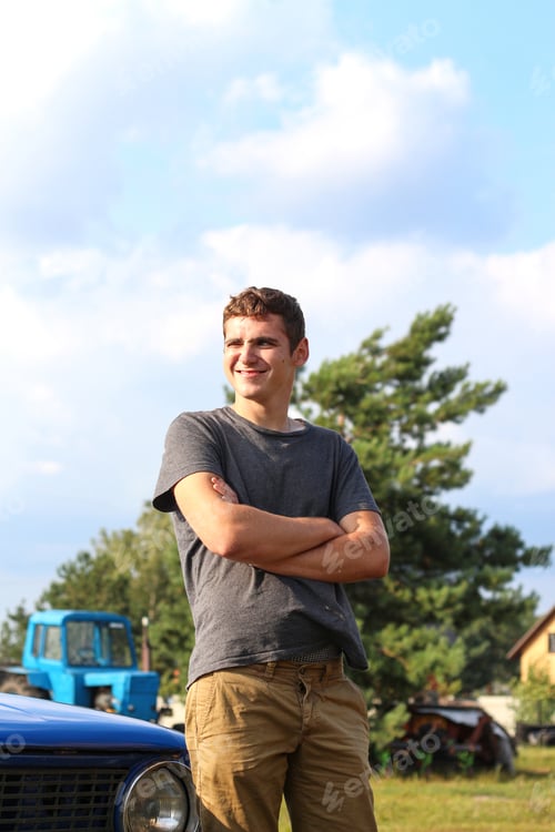 Preview: Outdoor portrait of a young Caucasian man in his 20s. Young handsome man with a happy smile, arms cr