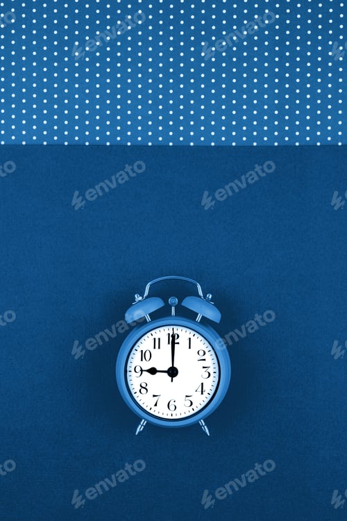 Preview: Alarm clock over the blue background