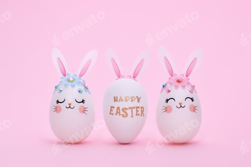 Preview: Three Easter eggs in a row on a pink background with copy space.