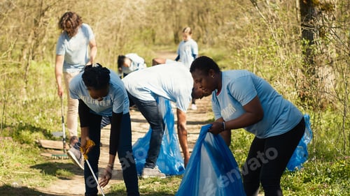 Preview: Environmental activists collecting rubbish and plastic waste in garbage bag